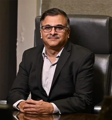 Jatin Kulkarni, Director of IRIX Technologies, seated at a desk in a dark suit